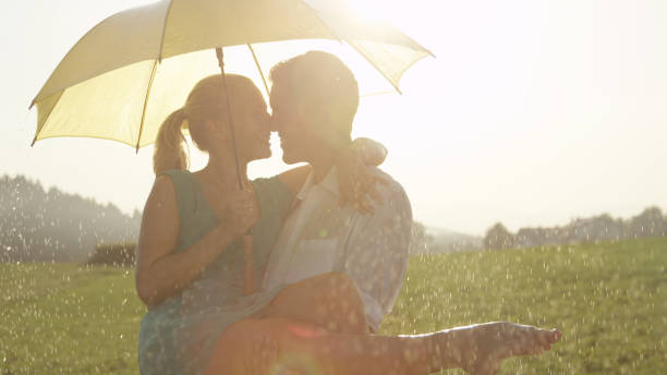 istock CLOSE UP: Embraced young couple is about to kiss while dancing in summer rain. 1034600546