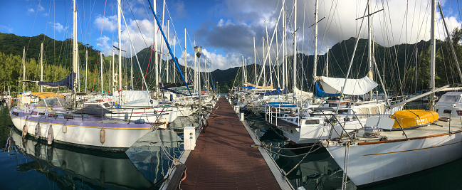 The pier and boats at Vaiare Marina on the island of Moorea. French Polynesia, South Pacific Ocean.