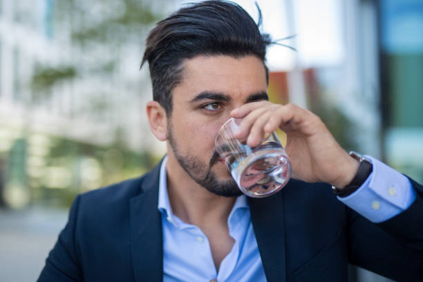 istock Handsome young businessman drinking water on break 1034603864