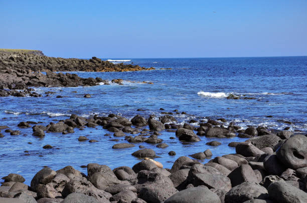 istock rocks, sea and blue sky 1034607646
