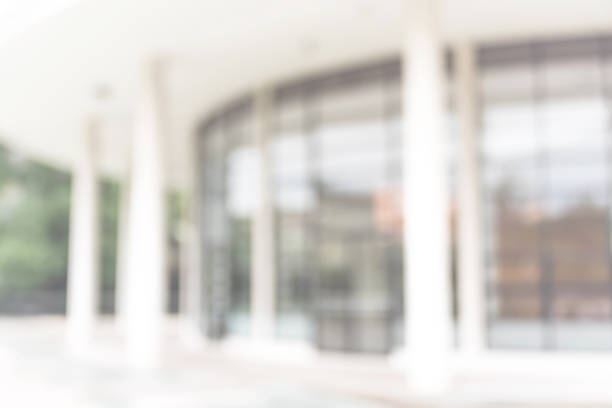 istock Office or university building blur background exterior view with blurry empty lobby space, entrance hall glass wall window and light bokeh 1034620068