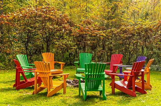 Inviting circle of muskoka chairs around a firepit in the early fall, Thanksgiving, concept, copy space