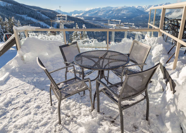 istock Chairs on a snow covered deck with a chairlift tower in the background. 1034629472