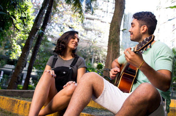 istock Man playing guitar to his girlfriend 1034630132
