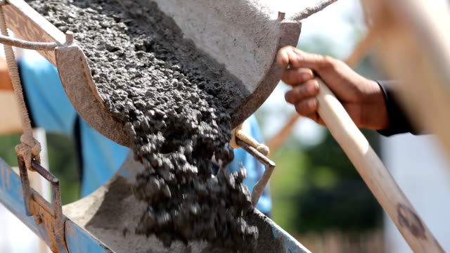 Cement truck is pouring cement on building site