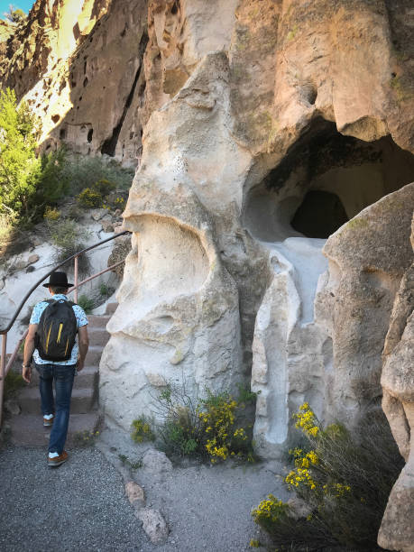 istock Bandelier National Monument, NM: Senior Man Climbs Steps 1034644366
