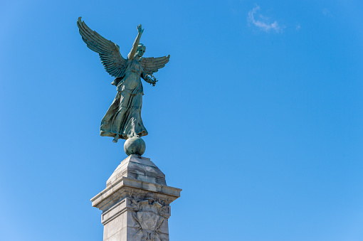 Angel Statue in Montreal in Mont Royal Park over blue sky