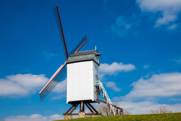 istock Windmill under a beautiful blue winter sky just before spring at the historical Bruges town 1034655040