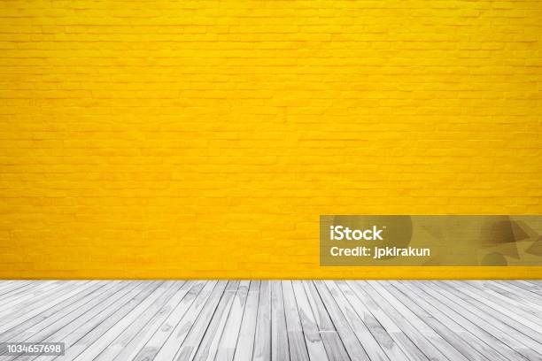 Yellow Brick Wall Texture With Wood Floor Background - Fotografias de stock e mais imagens de Amarelo