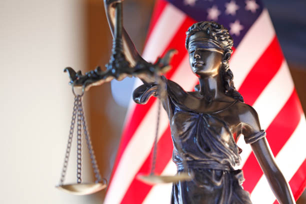 istock Lady Justice Statue In Front Of American Flag 1034660384