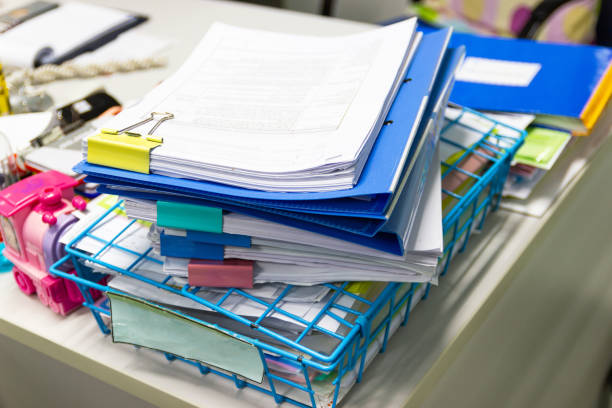 istock file folder and Stack of business report paper file on the table in a work office 1034665514