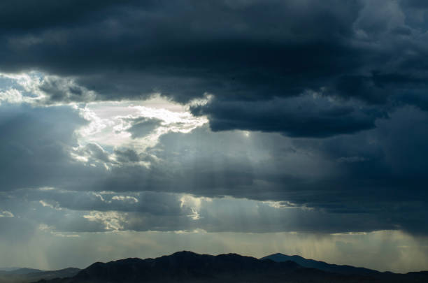 istock cloudy rainy sky over mountain in Mojave Desert 1034666276