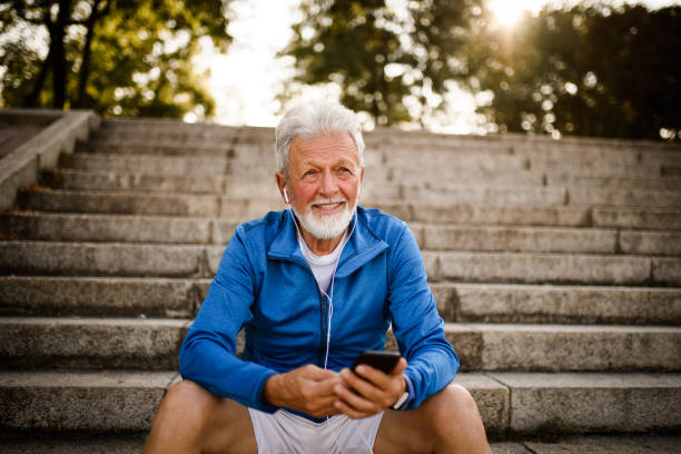 istock Sporty senior man using mobile phone. 1034680984