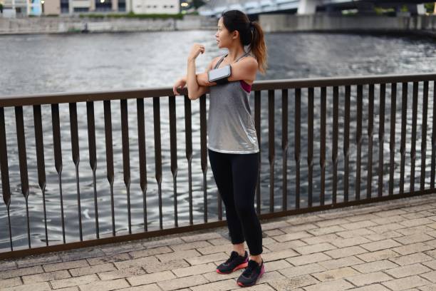 istock Young woman stretching before her run 1034680996