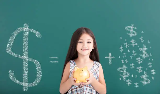 Photo of happy girl holding piggy bank and save money concept