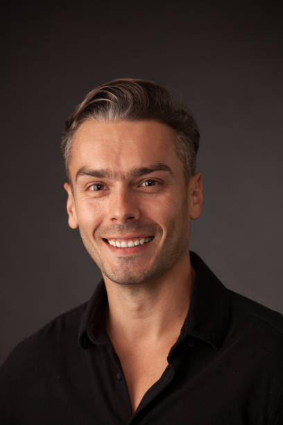 istock studio portrait of an attractive 30 year old man on a black background 1034710526