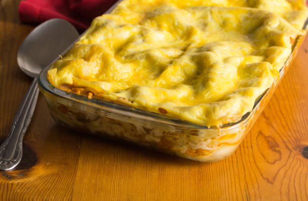 istock Lasagne dish on rustic wooden table - Layered pasta casserole 1034716372