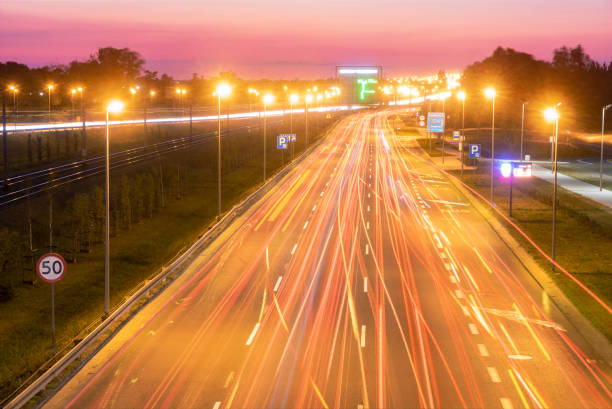 istock light trails on motorway highway at night, long exposure 1034728298