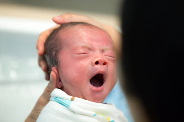 istock Asian newborn baby yawns, Two week old 1034746804