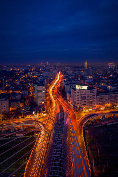 Cityscape long exposure with traffic lights and cars with modern buildings stock photo