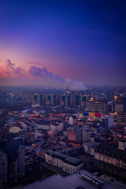 Morning view over the city from above during winter with a thermal energy plant making steam stock photo