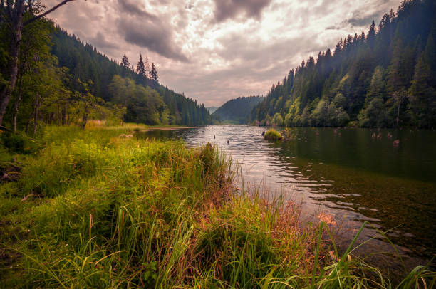 istock Beautiful lake surrounded by mountains on a cloudy day 1034754114