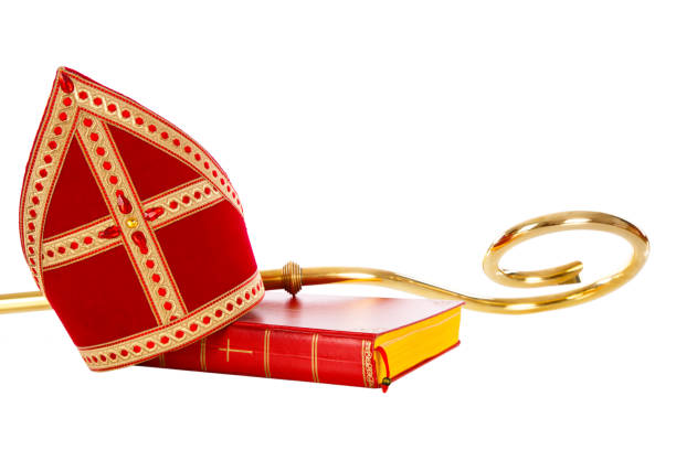 Mitre or miter book and staff of saint nicholas or Sinterklaas Mitre or miter book and staff of saint Nicholas. Isolated on white background. Part of a dutch Santa tradition mijter stock pictures, royalty-free photos & images