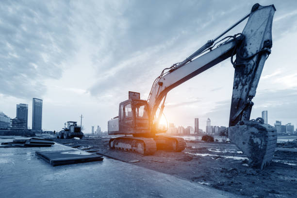 istock excavator in construction site on sunset sky background 1034761600