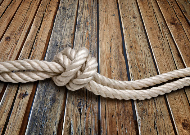 Cropped swirling tightrope and wooden planks on a Jetty in Annapolis, Maryland. Directly above, right copy space