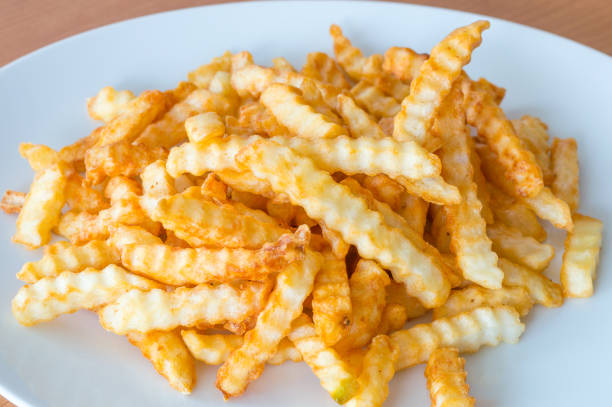 istock Corrugated fried French fries. 1034776726