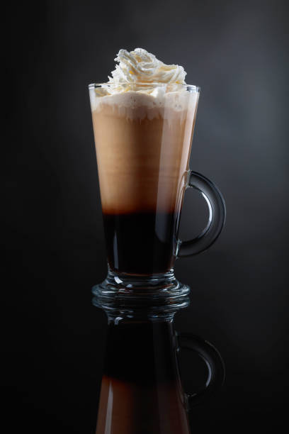 istock Coffee drink or cocktail with cream on a black background. 1034779172