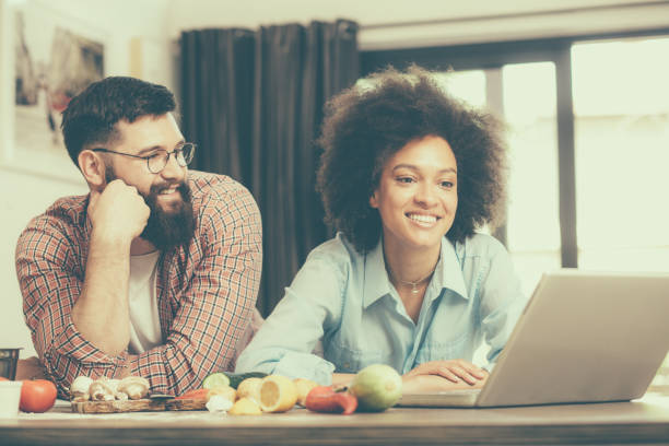 istock Mixed race family couple with lap top computer 1034783200