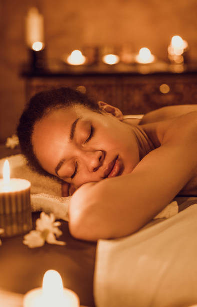 istock Relaxed black woman lying on massage table at the spa. 1034783300