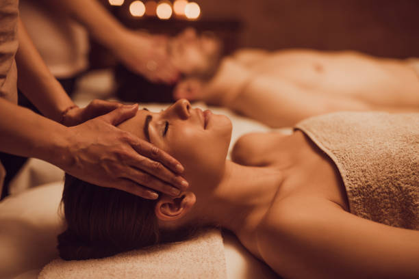 istock Young couple having relaxing head massage at beauty spa. 1034783600
