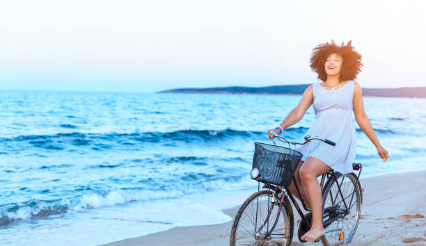 istock African Woman riding bicyle on sand 1034783998