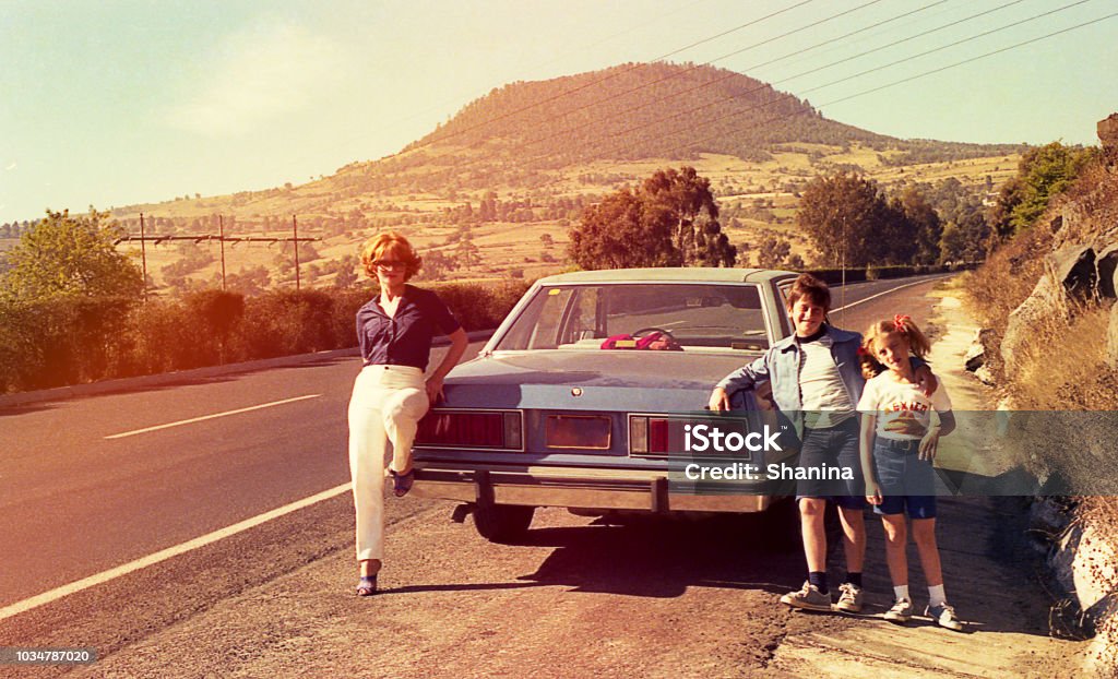 Vintage image of a family on the roads Vintage image of a mother and her children at a stop on the road. Retro Style Stock Photo