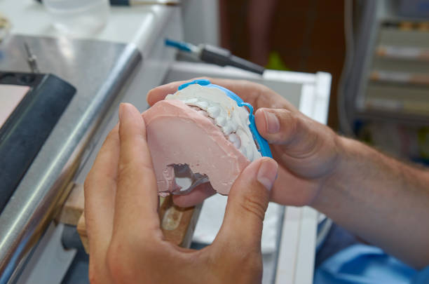istock Dental technician working with tools to do ceramic dental implants in his laboratory 1034787232
