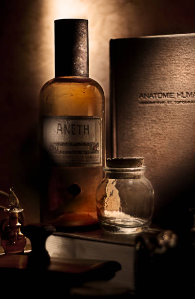 istock Bottle with anatomy book, still life. 1034791512