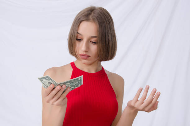 istock young girl and dollar in your hand 1034791614