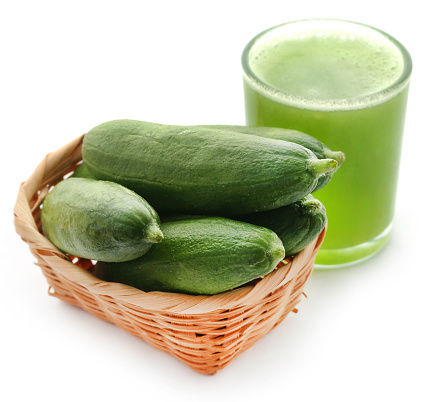 Fresh juice of green cucumber in a glass over white background