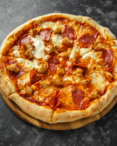 istock Home made rustic pizza with salami and chicken topped with melted mozzarella cheese 1034794018