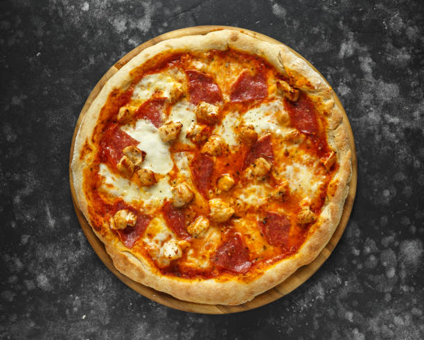 istock Home made rustic pizza with salami and chicken topped with melted mozzarella cheese 1034794054