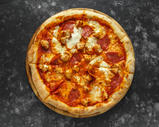 istock Home made rustic pizza with salami and chicken topped with melted mozzarella cheese 1034794056