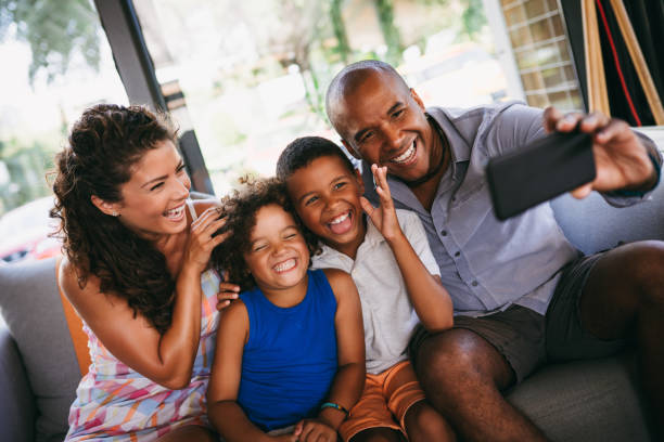 istock Happy family taking Selfie while sitting in cafe 1034800316
