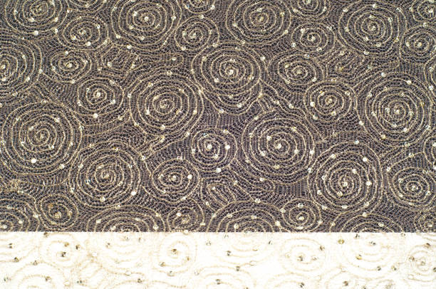 Texture, background, pattern. Lace fabric beige gold with sparkles. Amazing shimmery floral lace in antique toffee color with gold metallic thread in the spirit of Edwardian era.