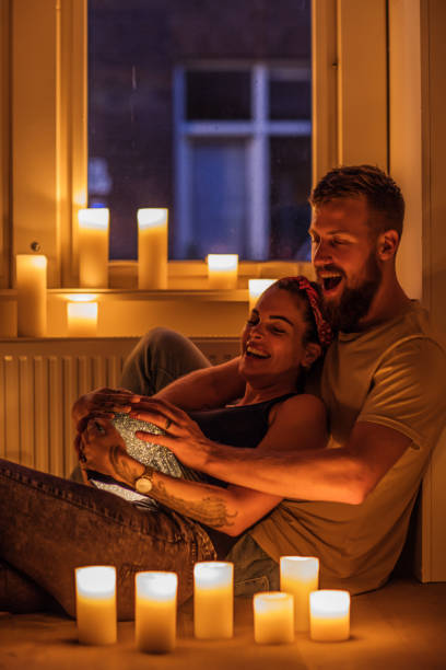 istock Young couple surrounded by candles 1034807392