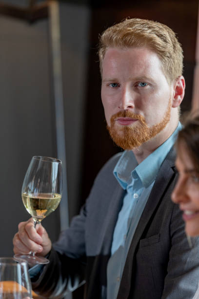 istock Red-haired businessman raising glass 1034808094