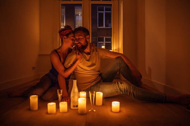 istock Young couple surrounded by candles 1034811868