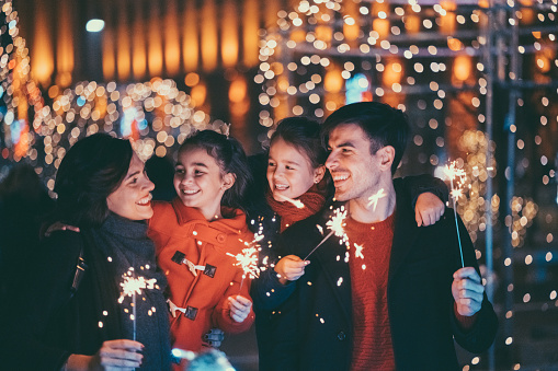 Young family with two kids celebrating New Year