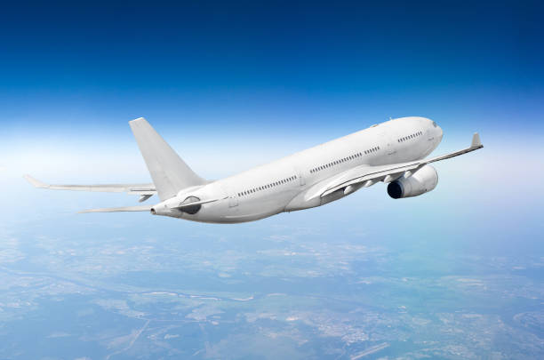 istock Flying airplane above the clouds horizon sky. 1034817692